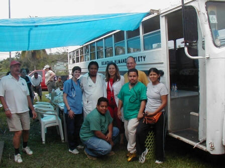 Belmopan Human Society early days. Goup of Member standing infront of Humane society first mobile bus.